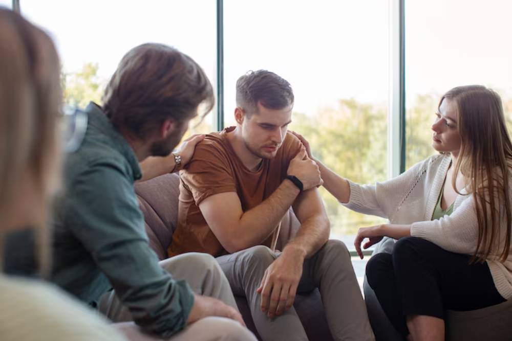 A group therapy session where participants are supporting one another, part of a Partial Care Program in New Jersey focused on emotional healing.