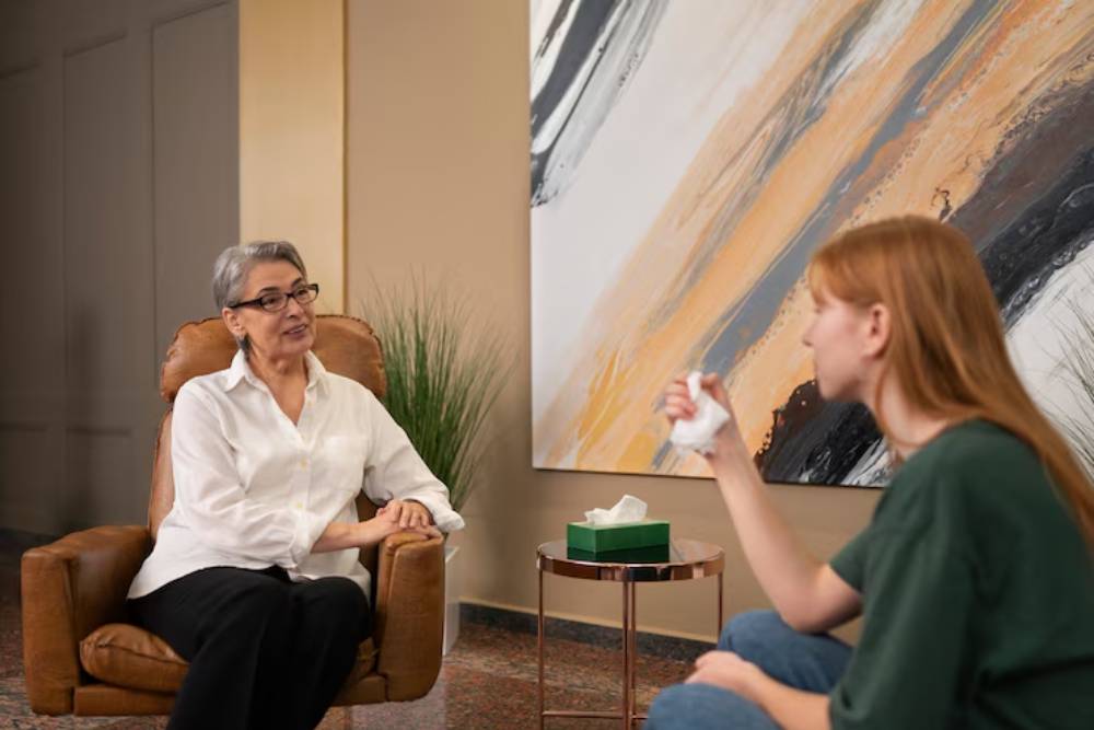 A therapy session between a counselor and a woman expressing emotions, illustrating one-on-one support in a Partial Care Program in New Jersey.